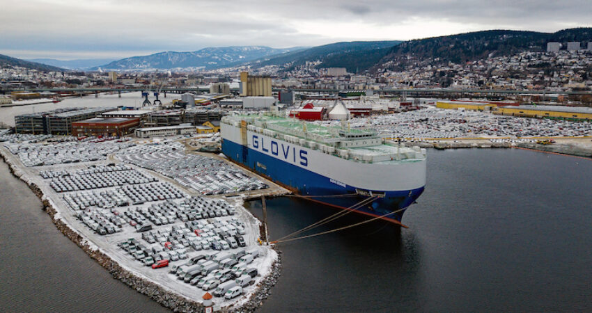 flyfoto av parkerte biler paa drammen havn, med baaten glovis til kai